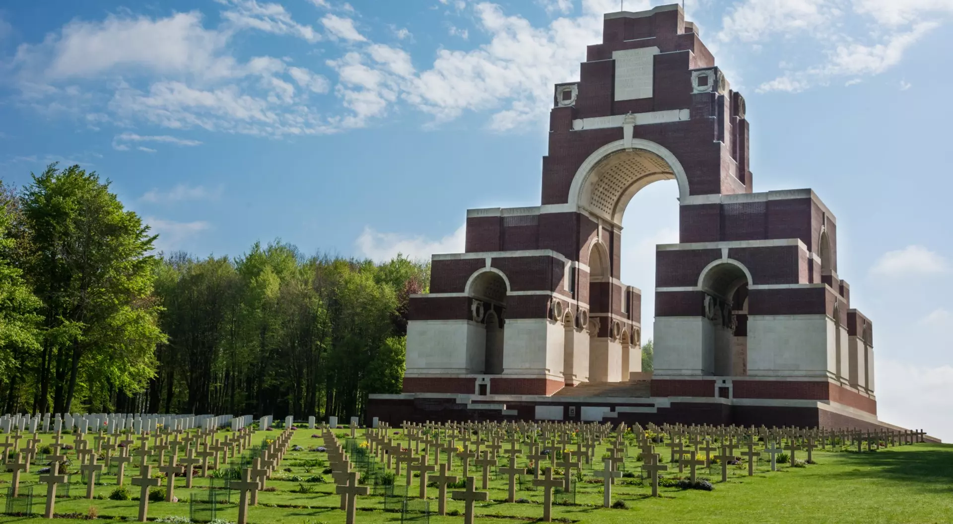 Thiepval War Memorial, France war memorial in front of graveyard on green field
