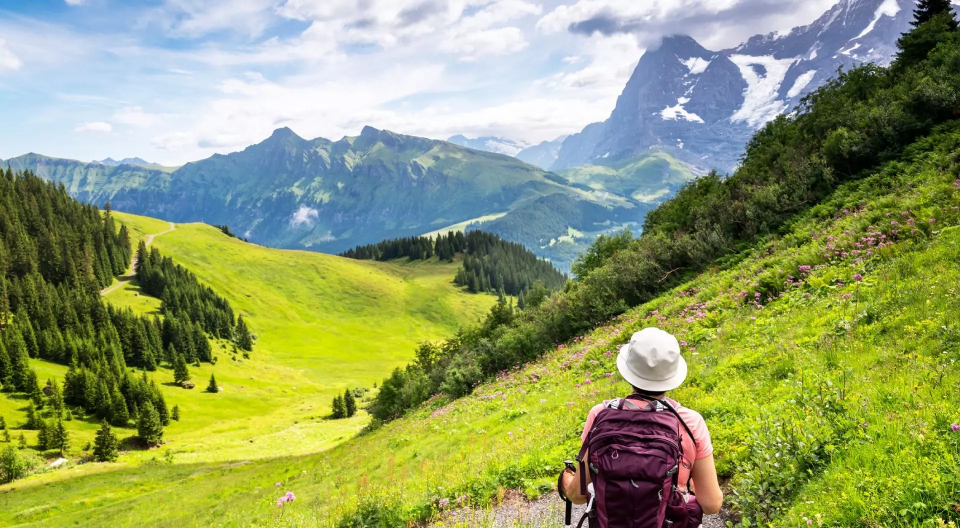 woman hiking through the Mountain view trail in the Swiss Alps in the Jungfrau region.