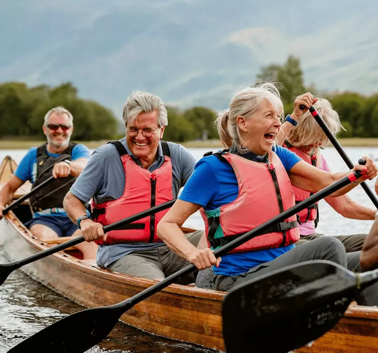 A senior group of tourists enjoying rowing on the River Derwent