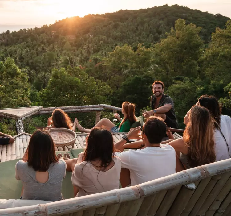 Group enjoys watching a sunset from a viewpoint