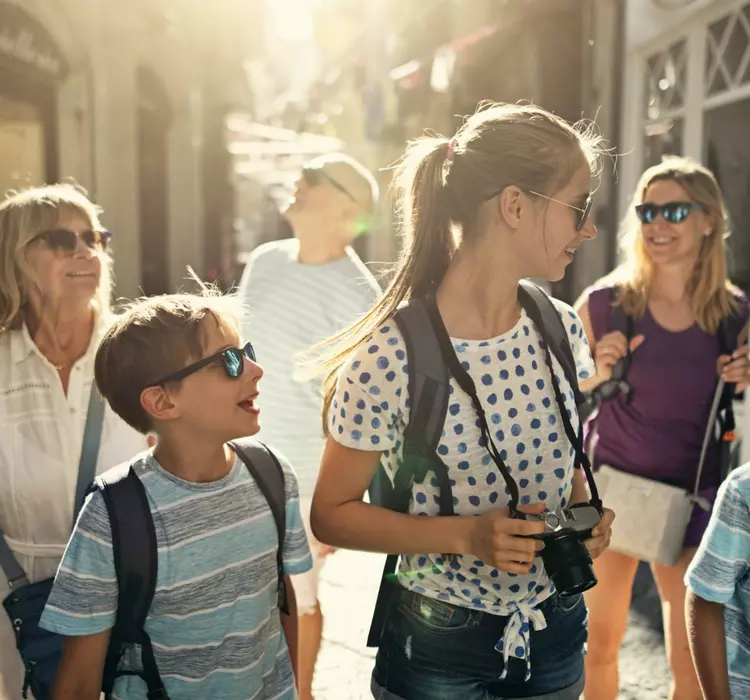 Multi generation family enjoying summer vacations. The family is walking in the narrow streets of an Italian town