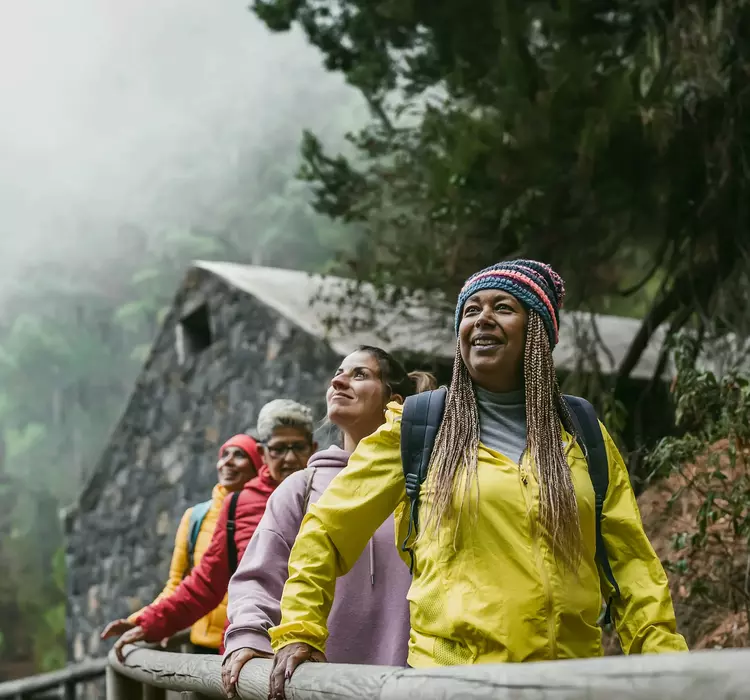 A group of older female travellings heading through a misty landscape in Spain