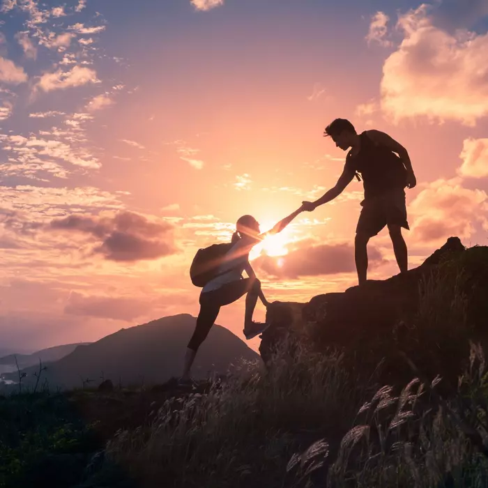 Mountain climbers help each other