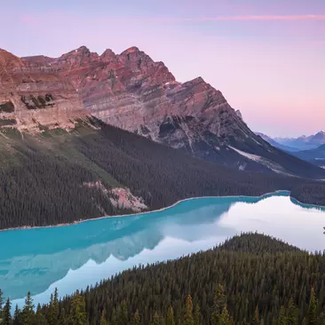Vibrant skies at sunrise over Peyto Lake in the Canadian Rockies
