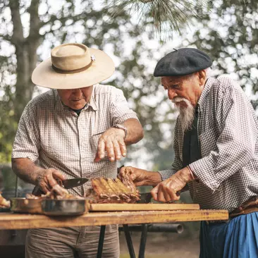 Argentine tradition, gauchos cutting a costillar or rib