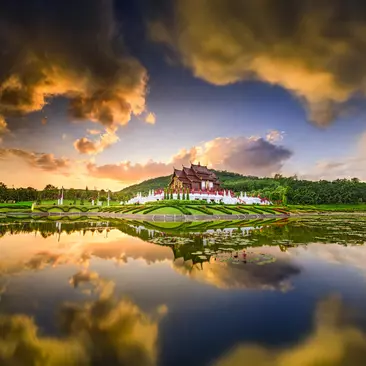 The Royal Flora Park in Chiang Mai Thailand at sunset with a reflection in the pond.