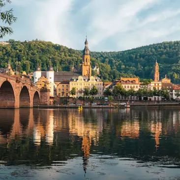 Reflections in the river of old buildings in Heidelberg Germany on Rhine