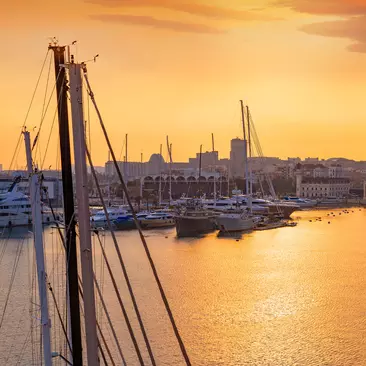 Sunset from the marina in Valencia with sail boats and the setting sun on the Mediterranean
