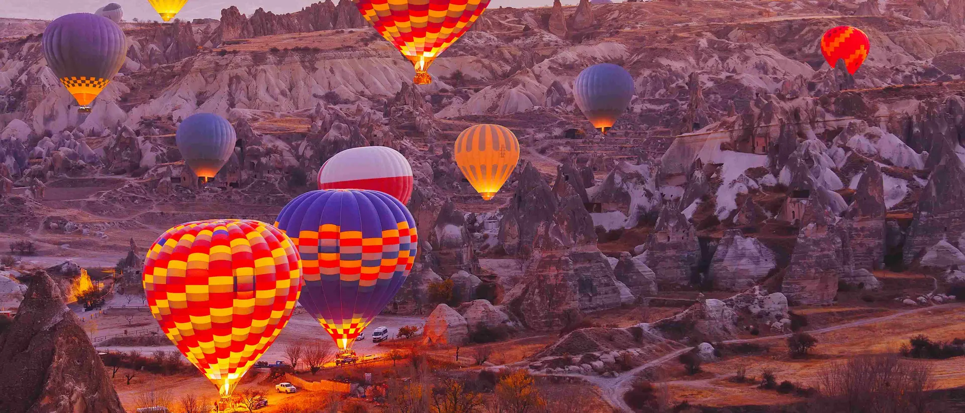 Scenic vibrant view of balloons in flight in Cappadocia Valley