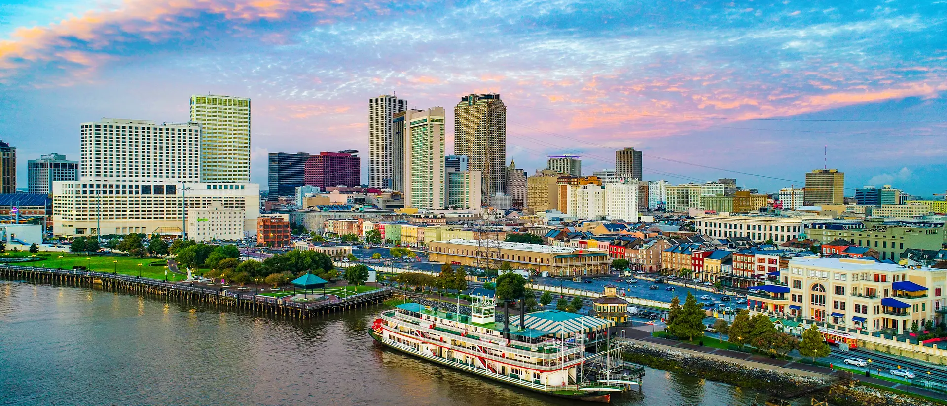 Skyline of city along the Mississippi river, steamboat in foreground