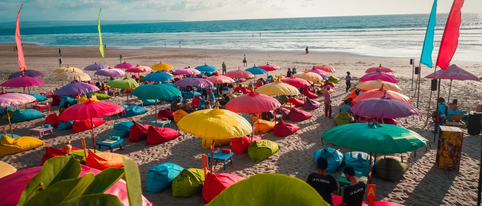 Colourful beach umbrellas with view of Double Six Beach, Seminyak, Bali, Indonesia