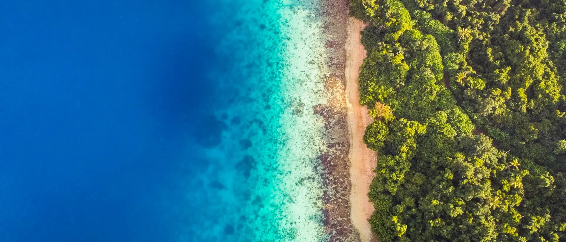 Tongatapu Aerial view of calm aqua marine blue water with tropical secluded beach