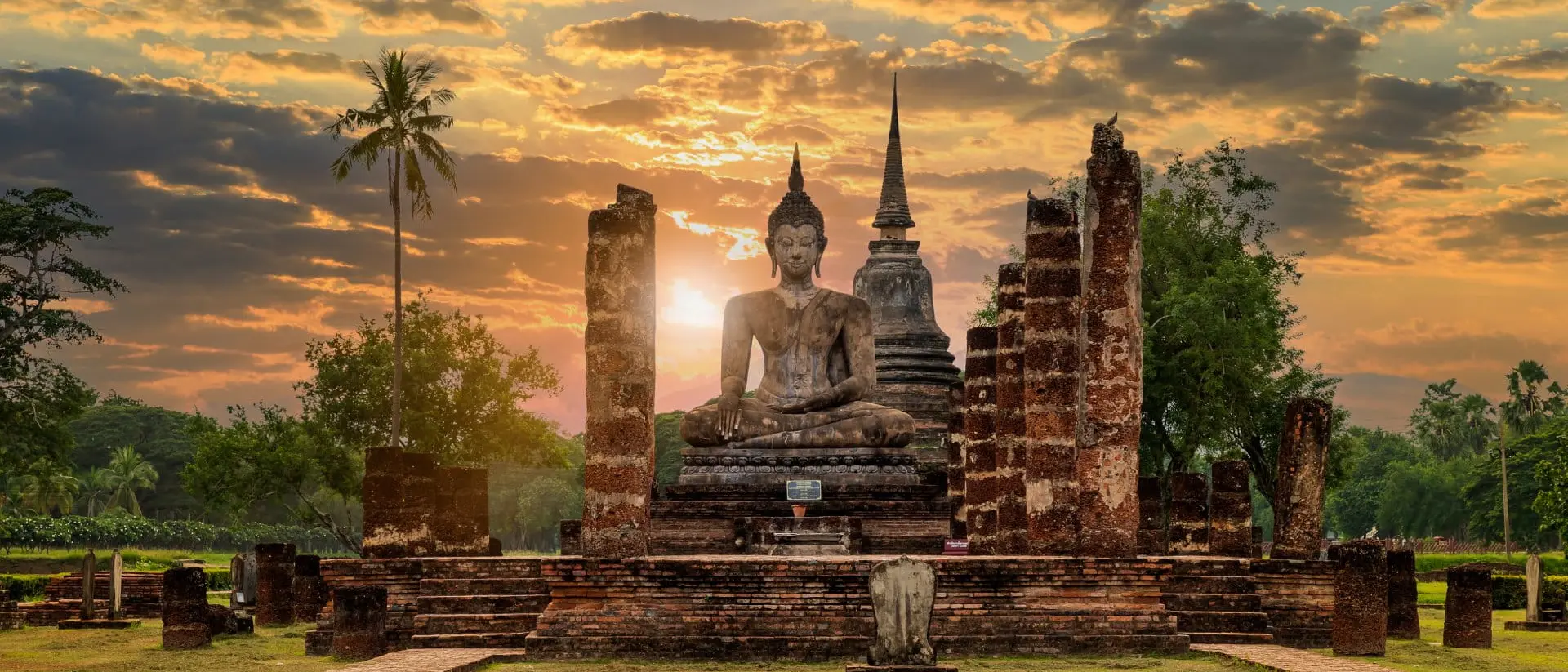 Wat Mahathat, Thailand Buddha statue and pagoda Wat Mahathat temple with dramatic syk