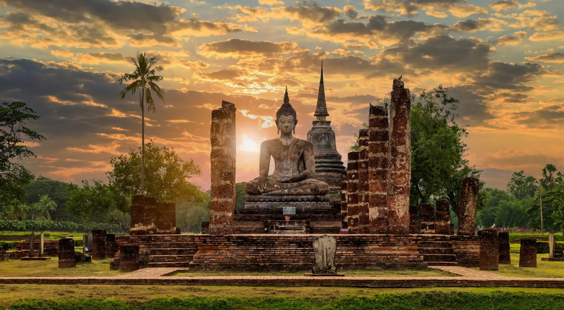 Wat Mahathat, Thailand Buddha statue and pagoda Wat Mahathat temple with dramatic syk