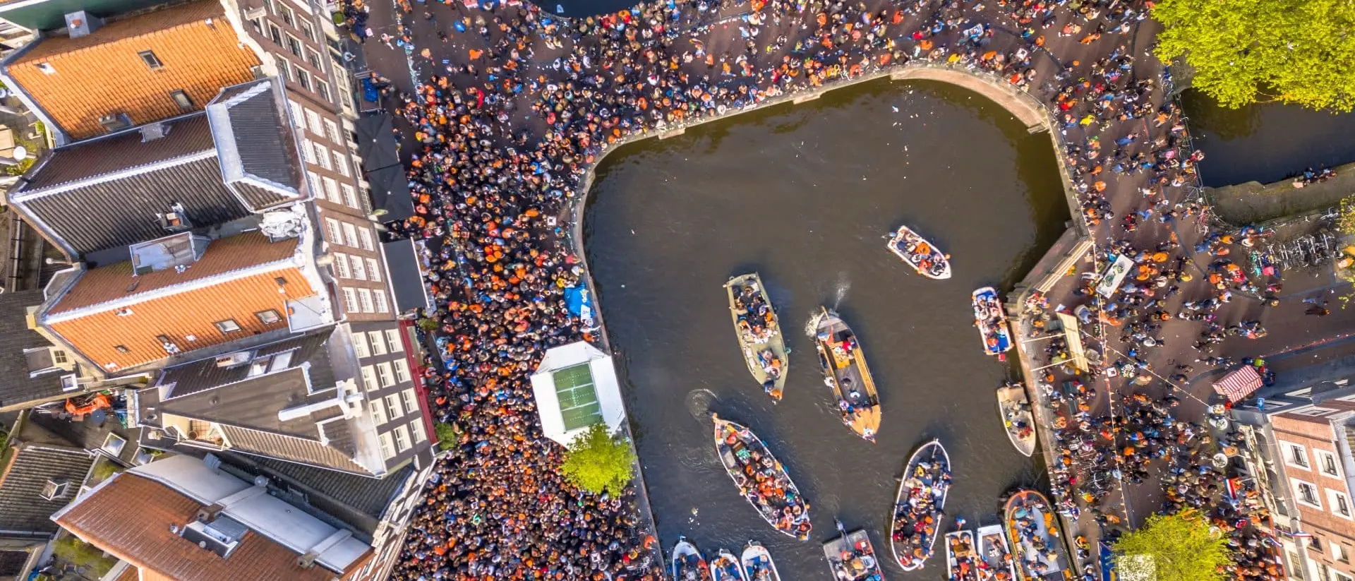 Amsterdam Canal boat parade on Koningsdag Kings day festivities in Amsterdam. Birthday of the king