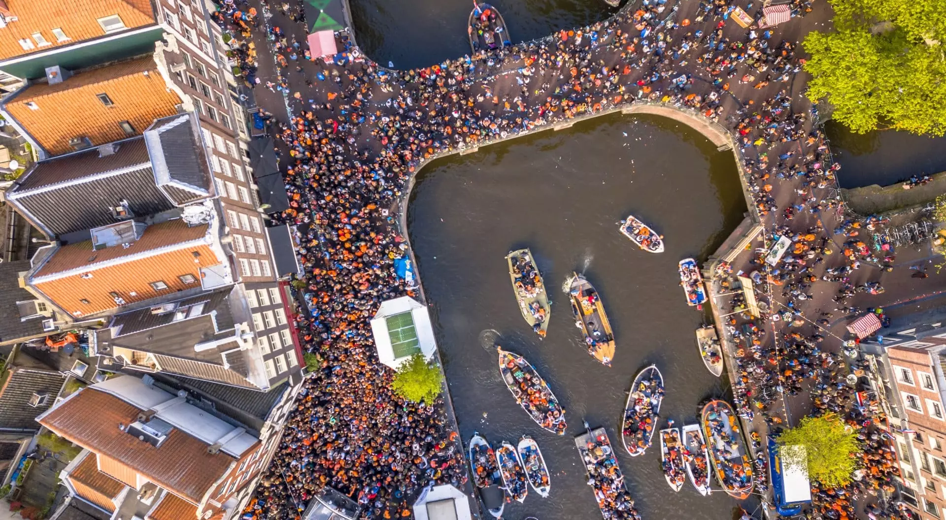 Canal boat parade on Koningsdag Kings day festivities in Amsterdam. Birthday of the king