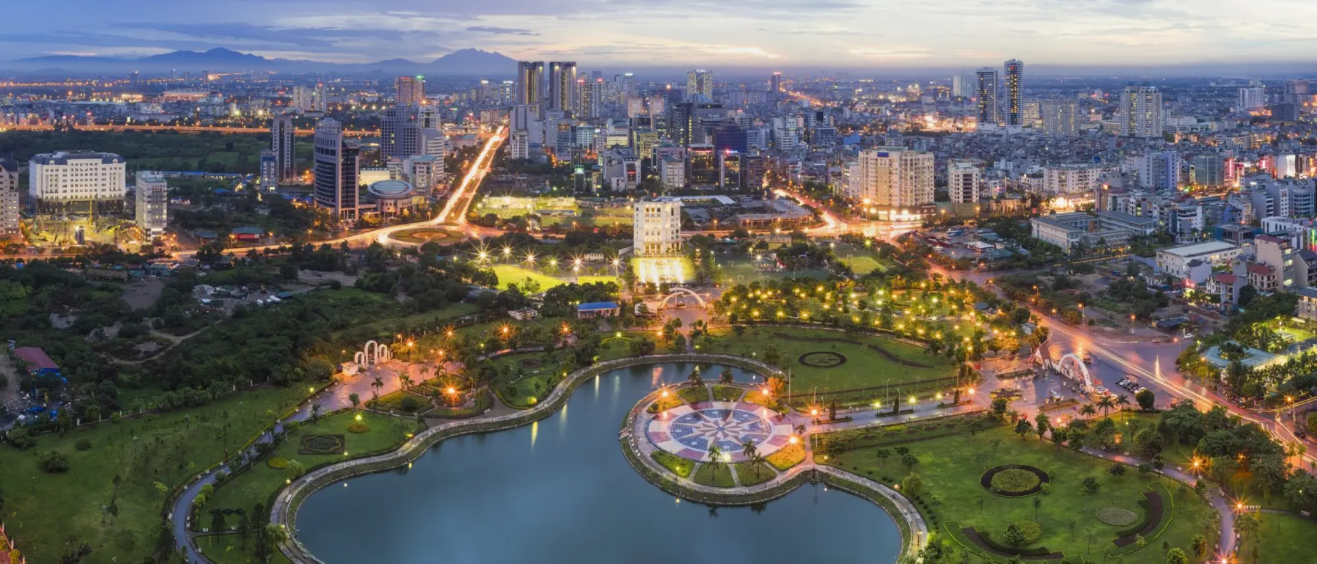Hanoi skyline cityscape at twilight period, with Cau Giay Park in foreground