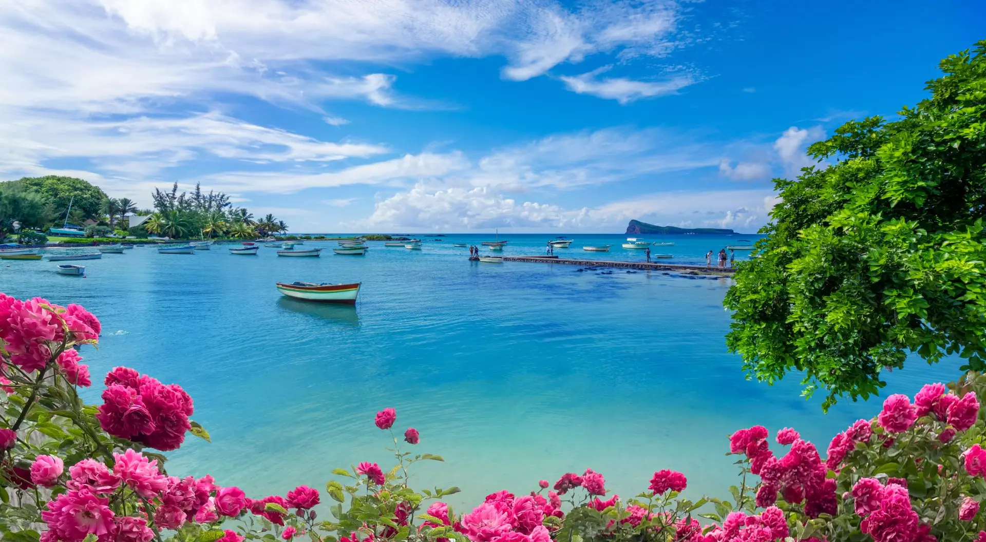 "Landscape view of the blue transparent sea, boats and beach in the summertime in Mauritius "