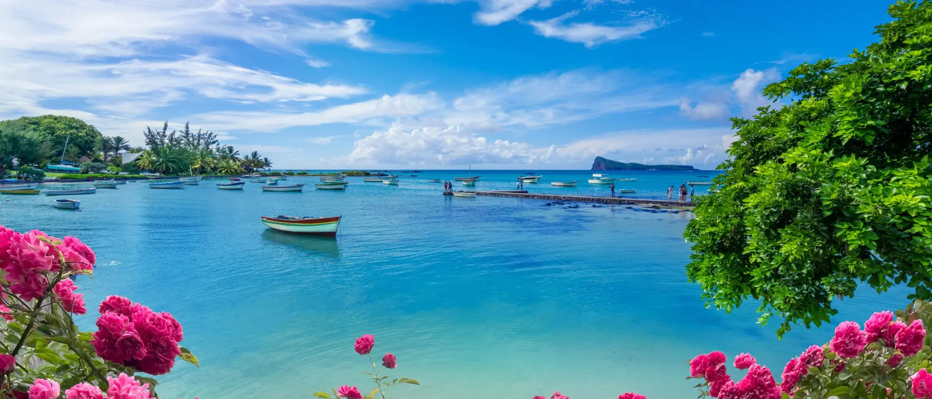 "Landscape view of the blue transparent sea, boats and beach in the summertime in Mauritius "