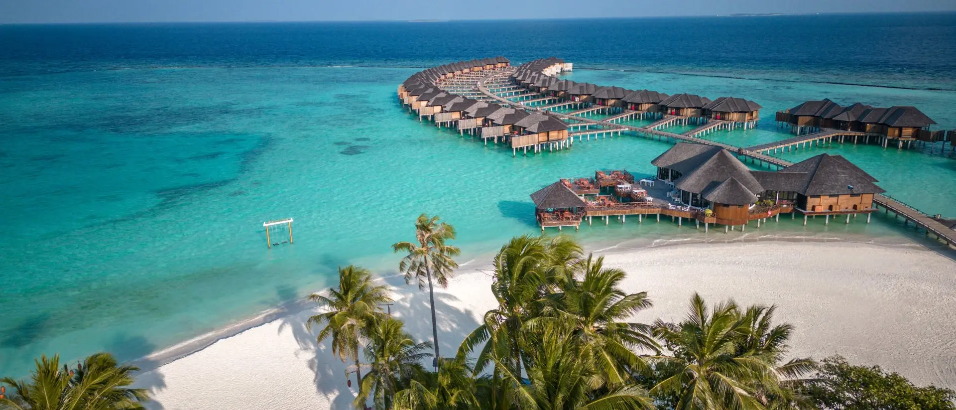Maldives Maldives hotel beach resort on tropical Island with aerial drone view