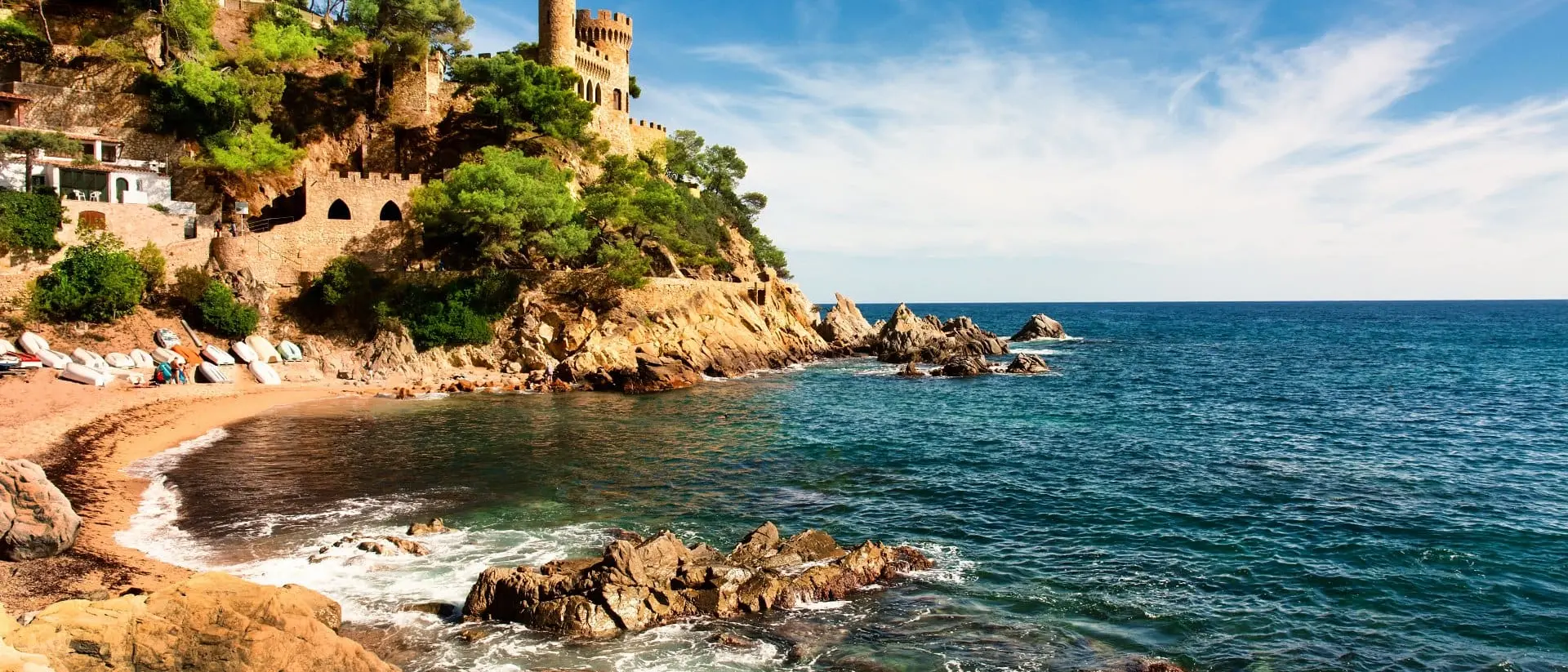 Medieval castle overlooking balearic coast and stunning beach