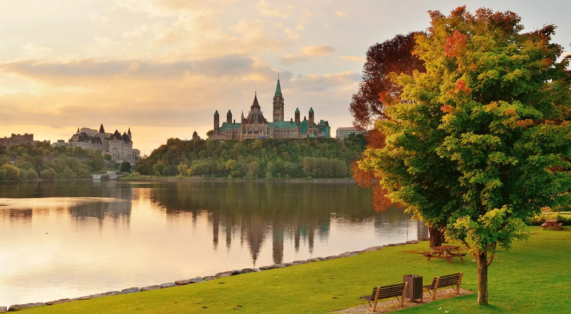 Ottawa city skyline with Parliament Hill at sunrise in the morning park view over river