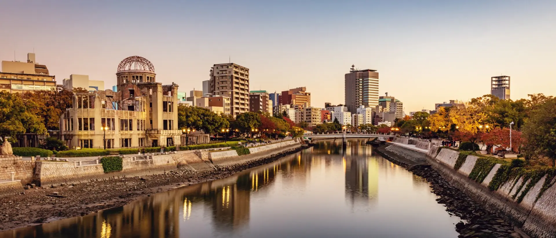 Honshu Panorama of Hiroshima Cityscape at Twilight. View over the Ota River, Atomic Bomb Dome illuminated on the left side of the river