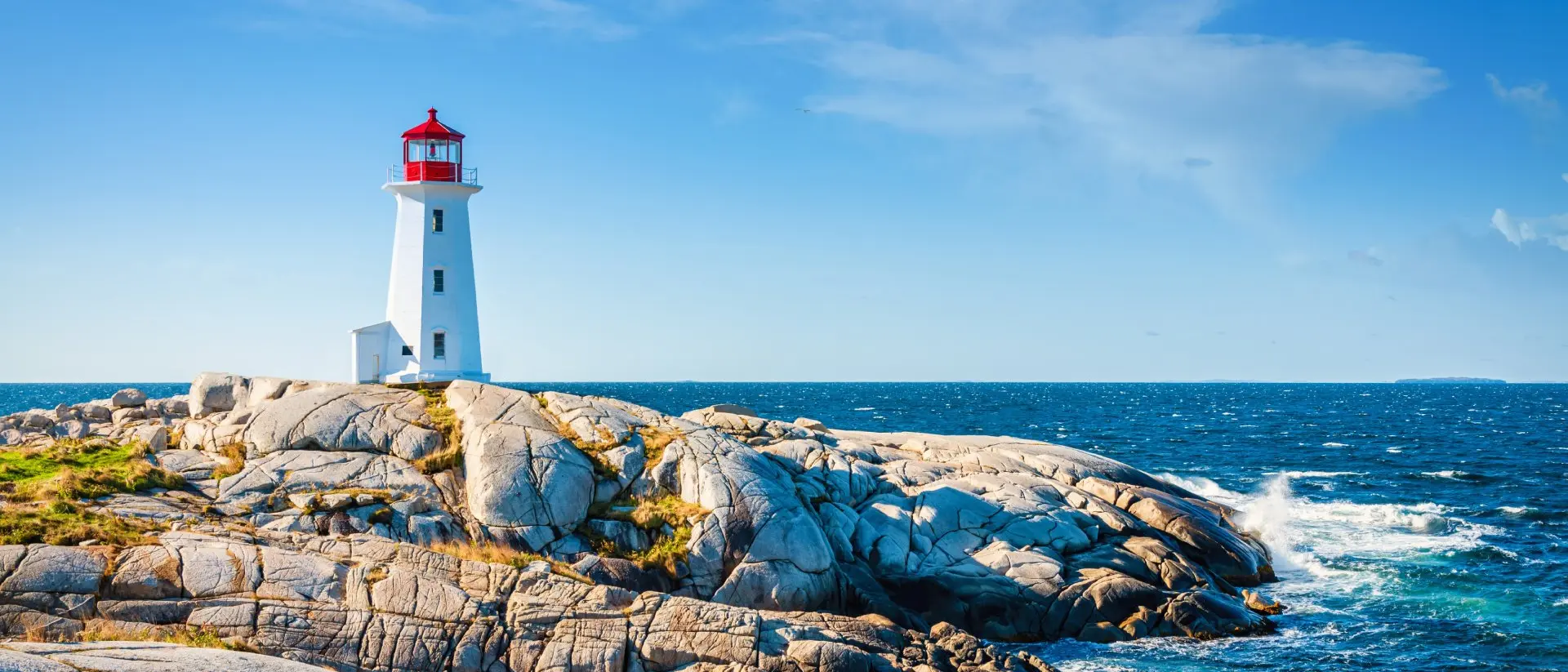 Peggy's Cove Lighthouse, Halifax Peggy's Cove Lighthouse under blue summer sky on the coast of the Atlantic Ocean.
