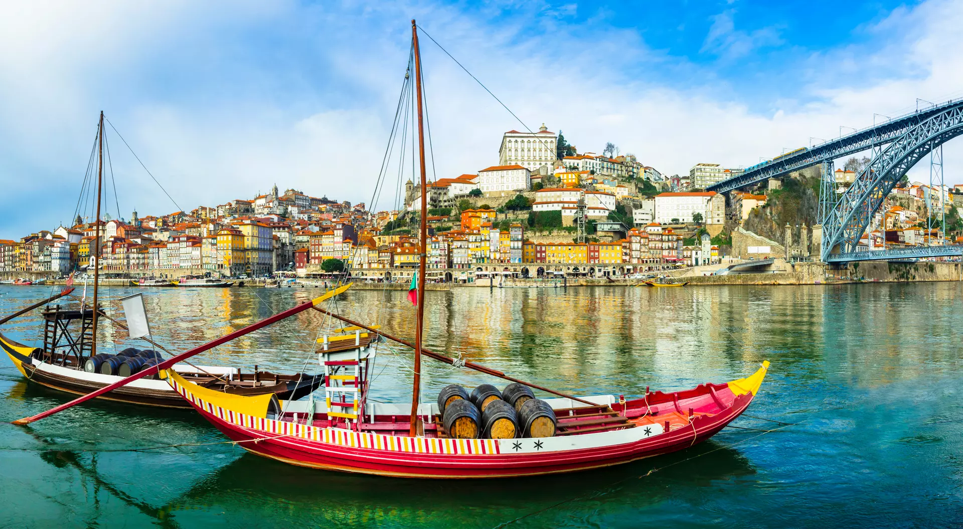 Panorama of beautiful Porto with traditional boats on the river