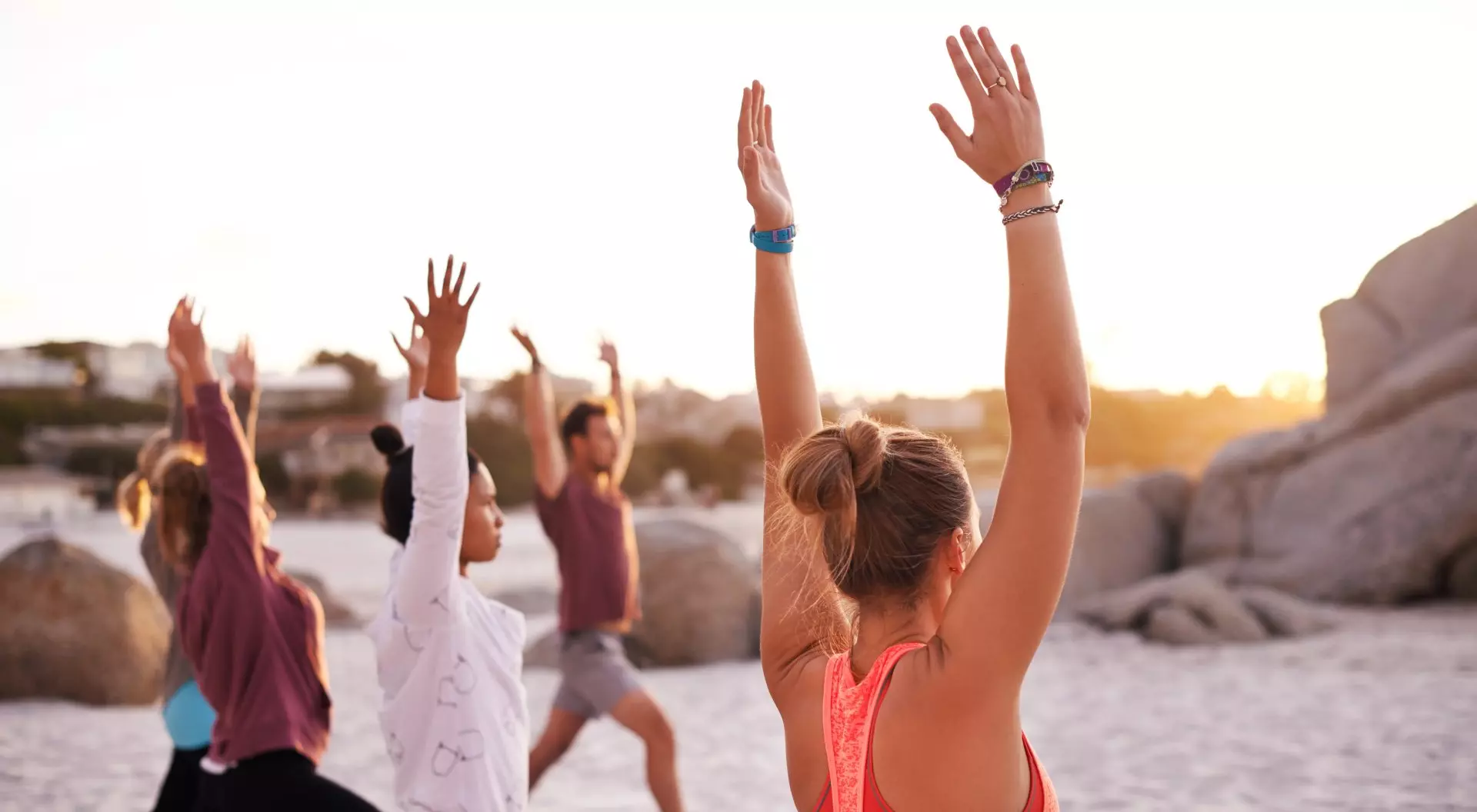 Shot of a group of people having a yoga session on the beach