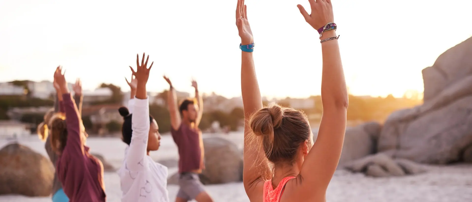 Shot of a group of people having a yoga session on the beach