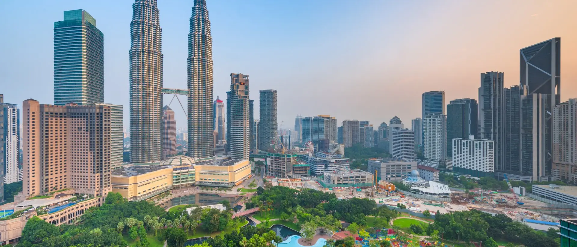Petronas Twin Towers Sunset skyline view of Kuala Lumpur featuring the Petronas Twin Towers, an interlinked pair of 88-storey skyscrapers