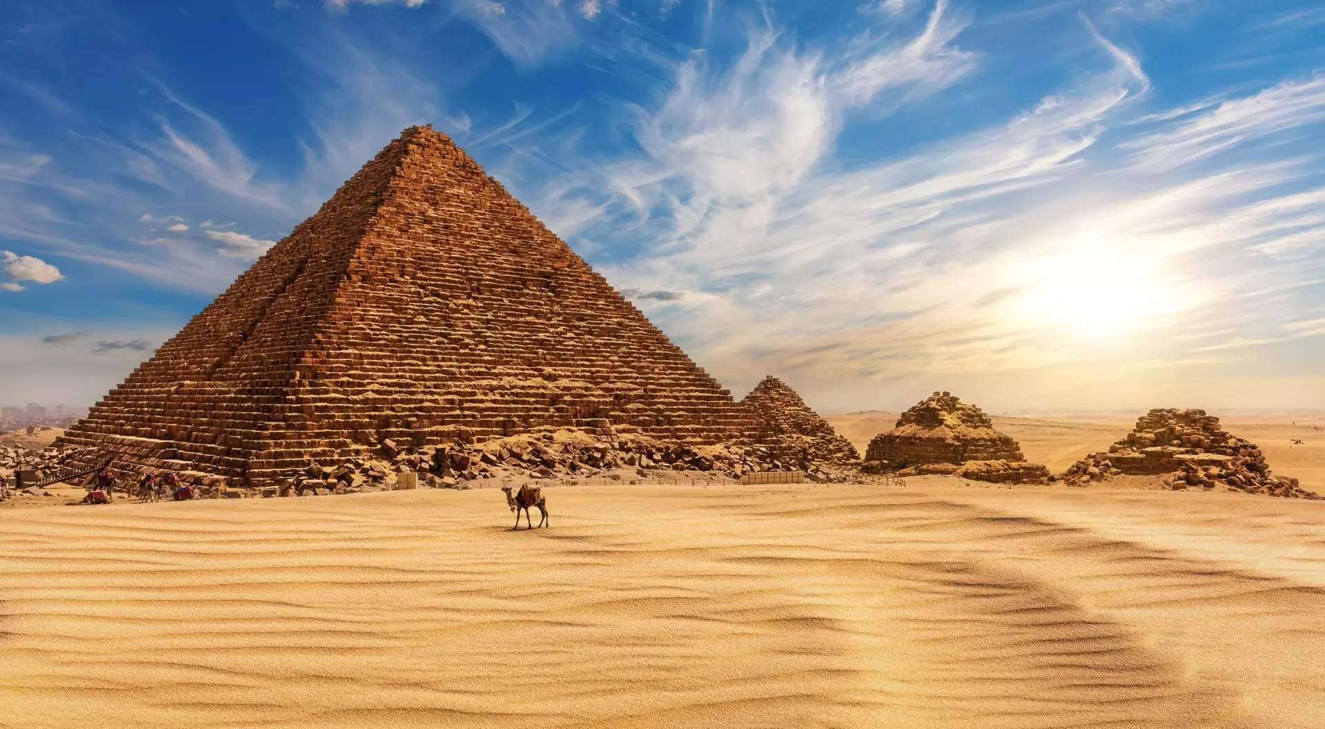 The Pyramid of Menkaure at sunset in Egypt and a camel nearby