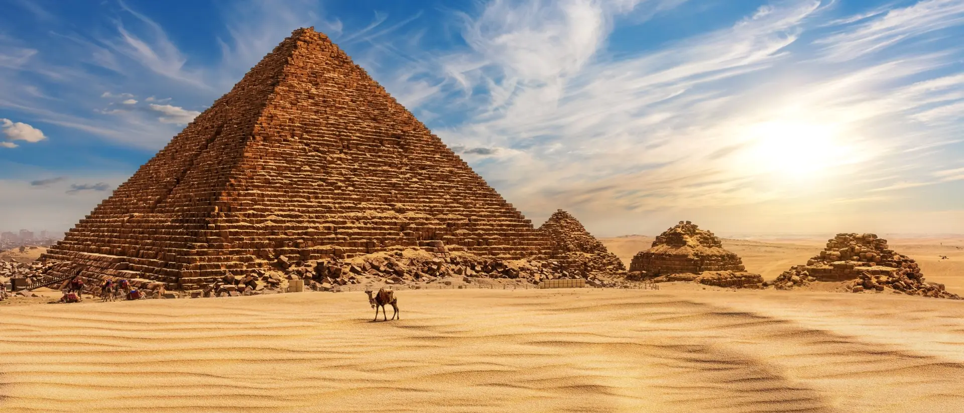 The Pyramid of Menkaure at sunset in Egypt and a camel nearby