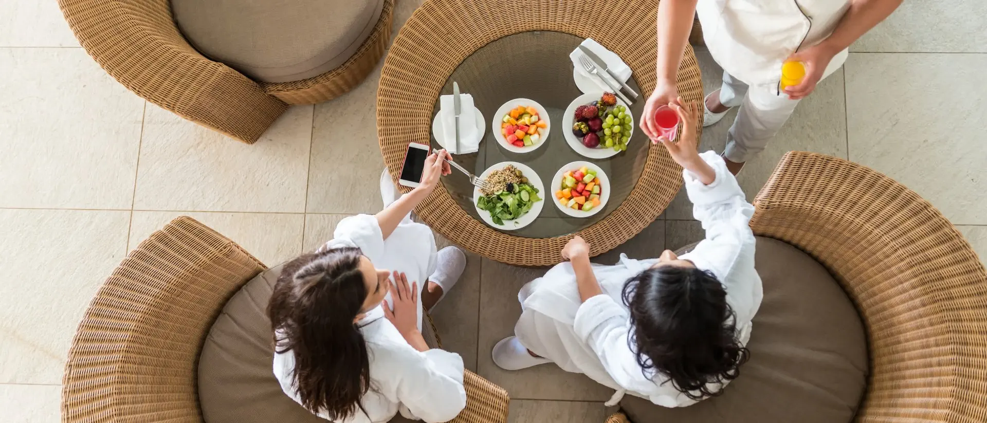 Therapist Serving Fresh Juice to Two Women