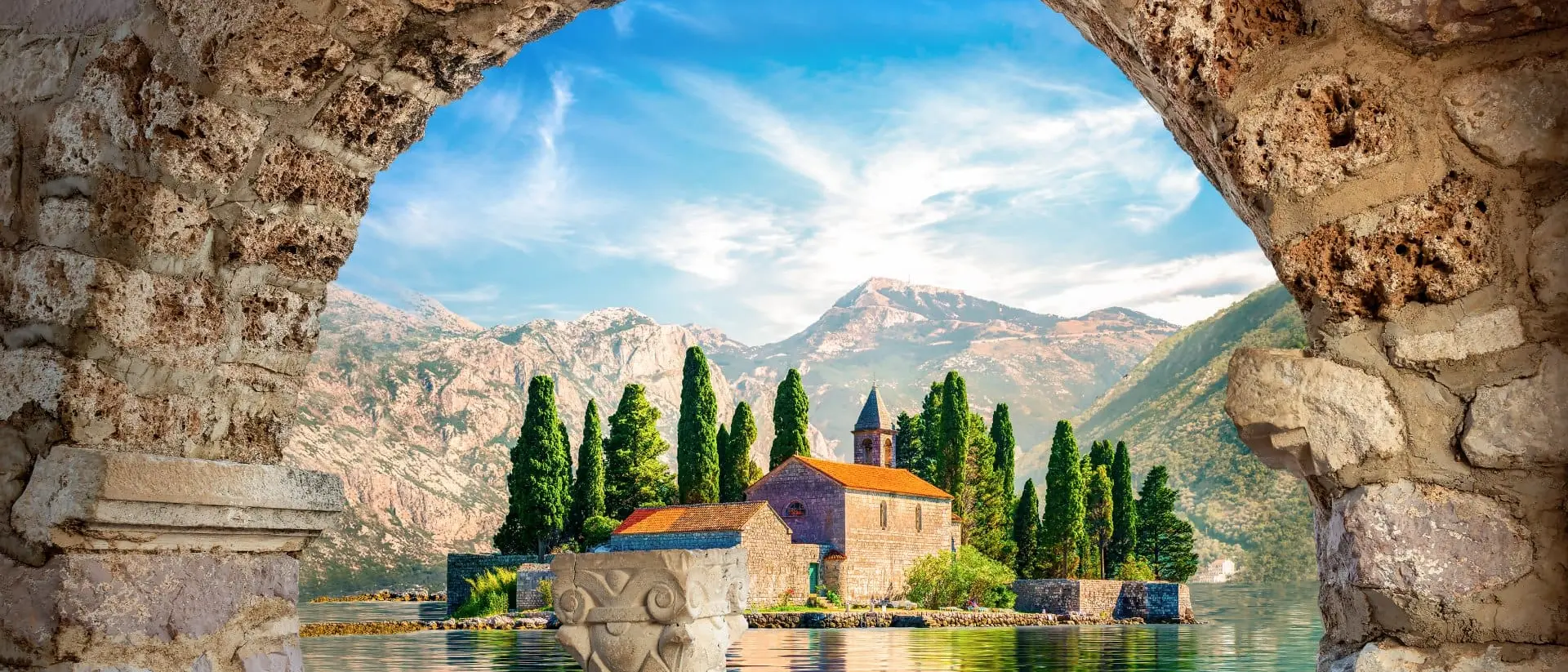 Perast, Montenegro View on St George island from Our Lady of the Rocks through arch