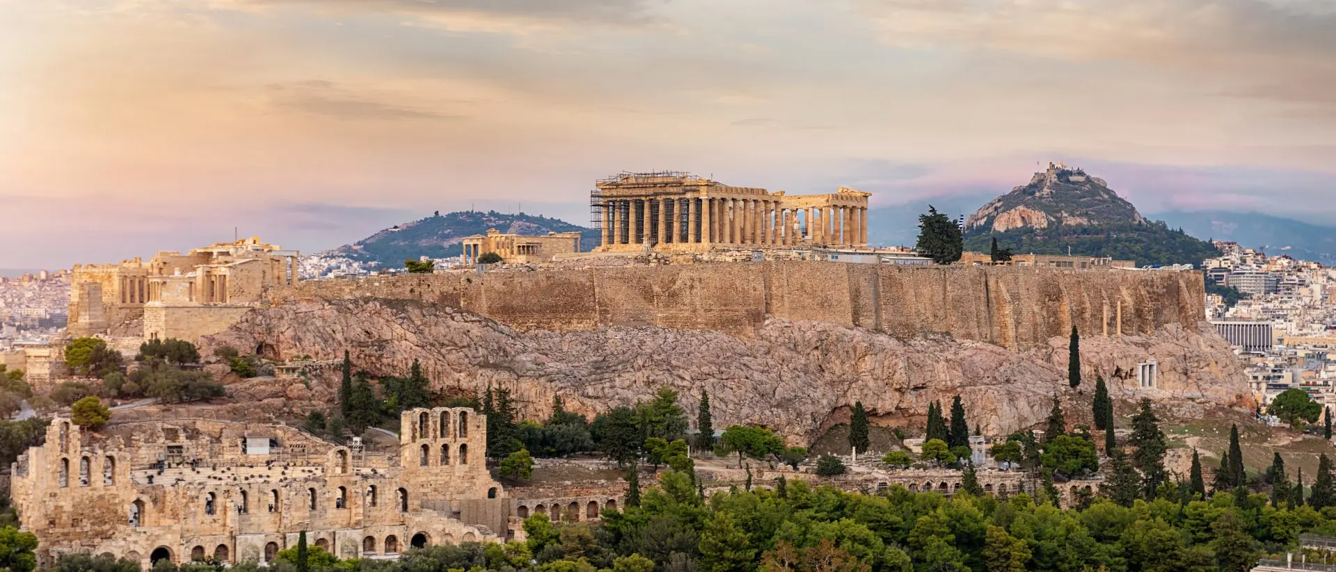 Acropolis of Athens View to the Acropolis of Athens on top of the old town Plaka during a cloudy summer sunset, Greece