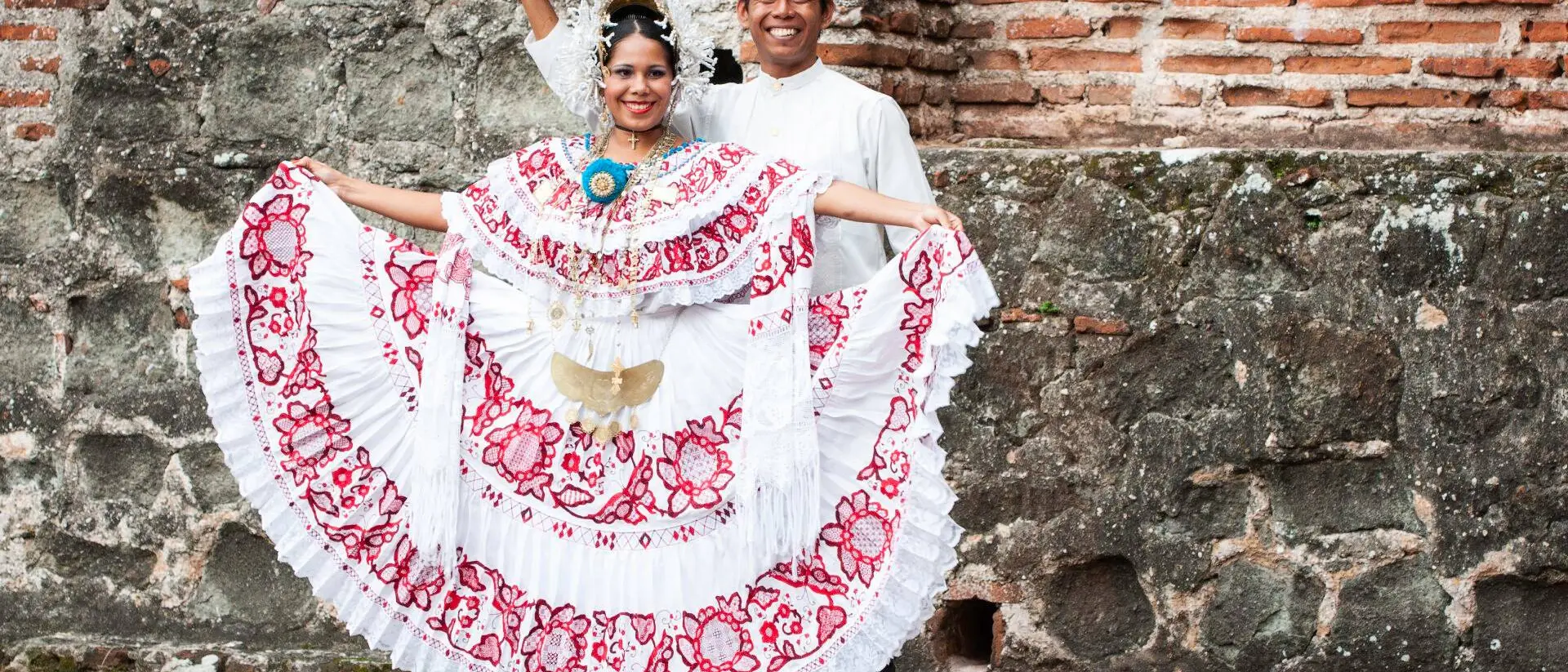 Panama City Woman wearing a pollera Panama's national costume, and man wearing a traditional tunic mole at Panama la Vieja ruins, Panama City, Panama