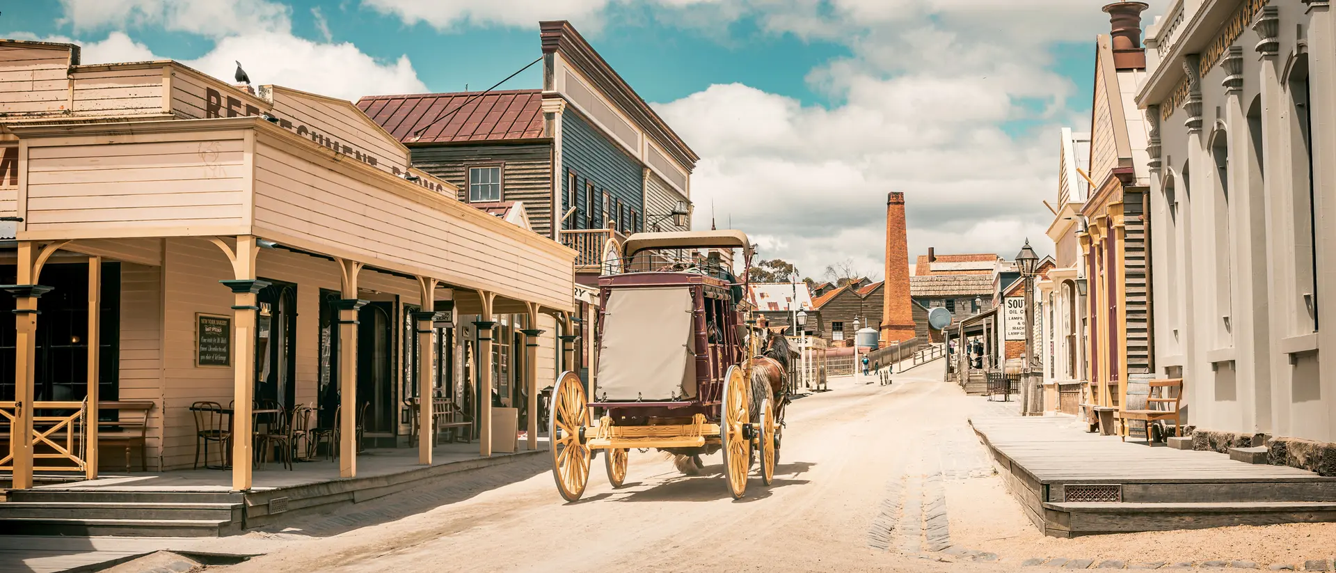 An old horse-drawn carriage moves through the replica mining town of Sovereign Hill in Ballarat, Australia