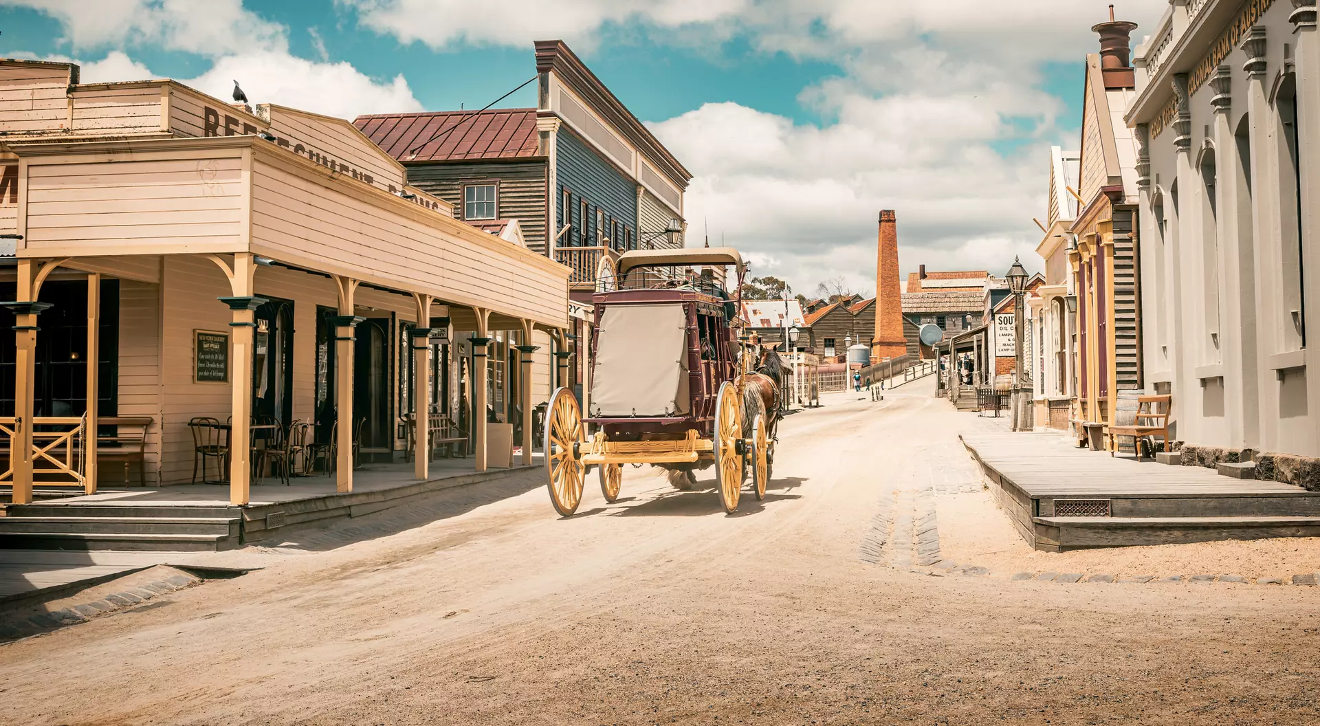 An old horse-drawn carriage moves through the replica mining town of Sovereign Hill in Ballarat, Australia