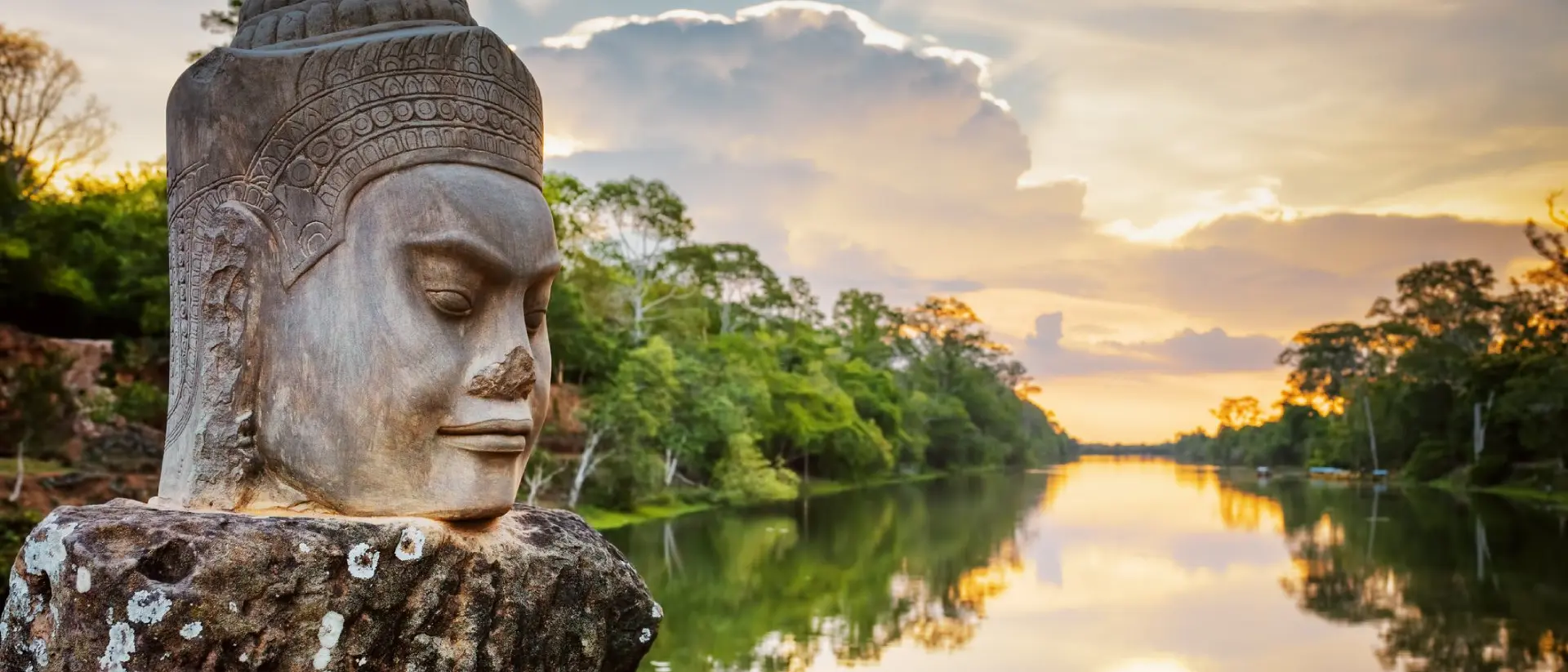 Stone face Asura and sunset over moat.