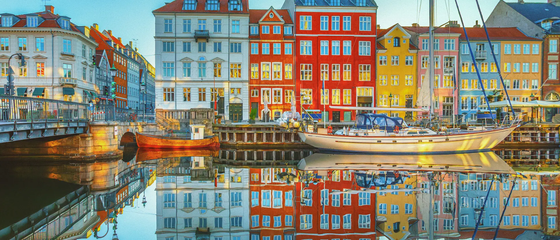 Nyhavn, Copenhagen View of clear waters reflecting the buildings of Nyhavn along the canals of Copenhagen, Denmark