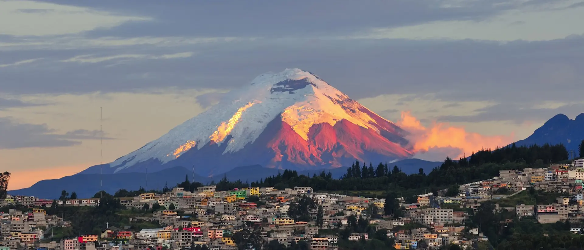 The last rays of sunlight illuminate the Cotopaxi Volcano