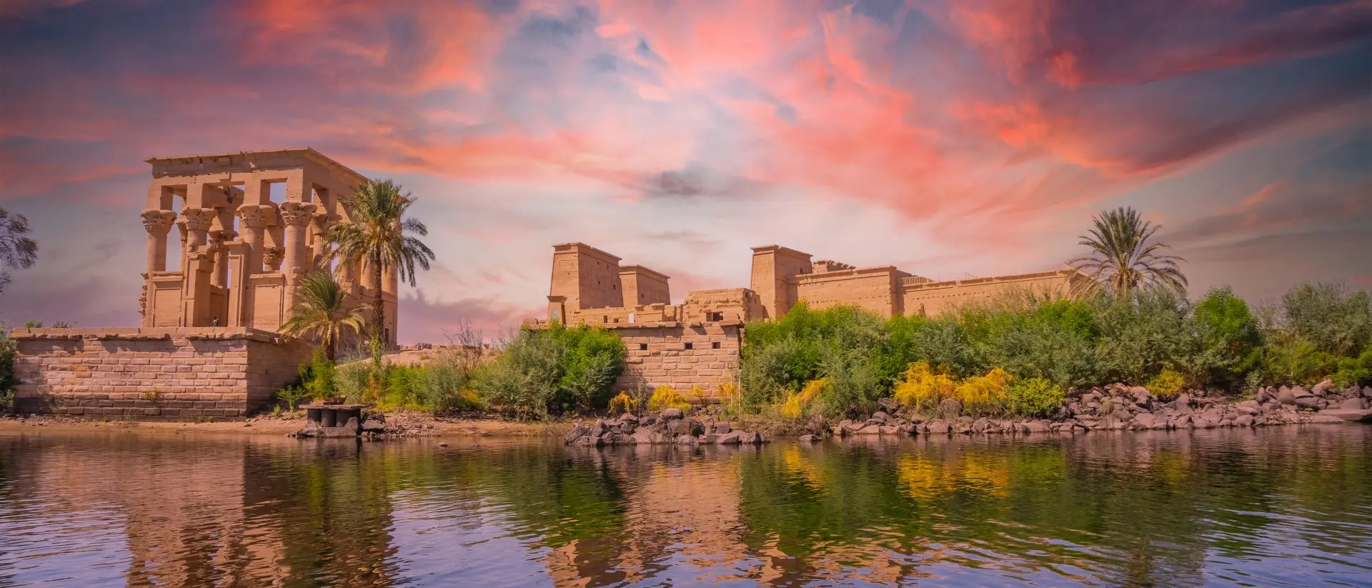 Temple of Philae, Aswan, Egypt Incredible orange sunrise at the temple of Philae, a Greco-Roman construction seen from the Nile river, a temple dedicated to Isis, goddess of love
