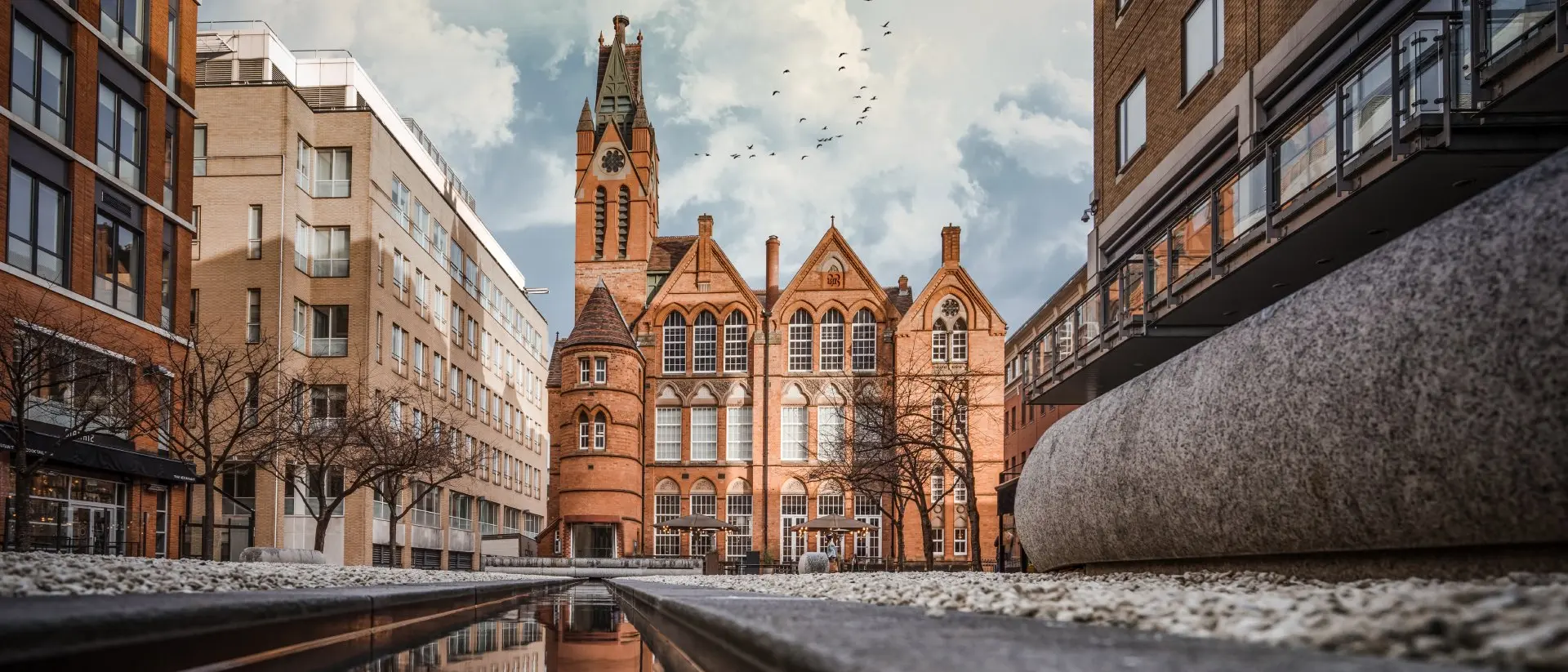 Brindley Place, Birmingham Brindley Place red brick church building reflected in water. West Midlands landmark buildings redevelopment in historic city centre reflection in stream.