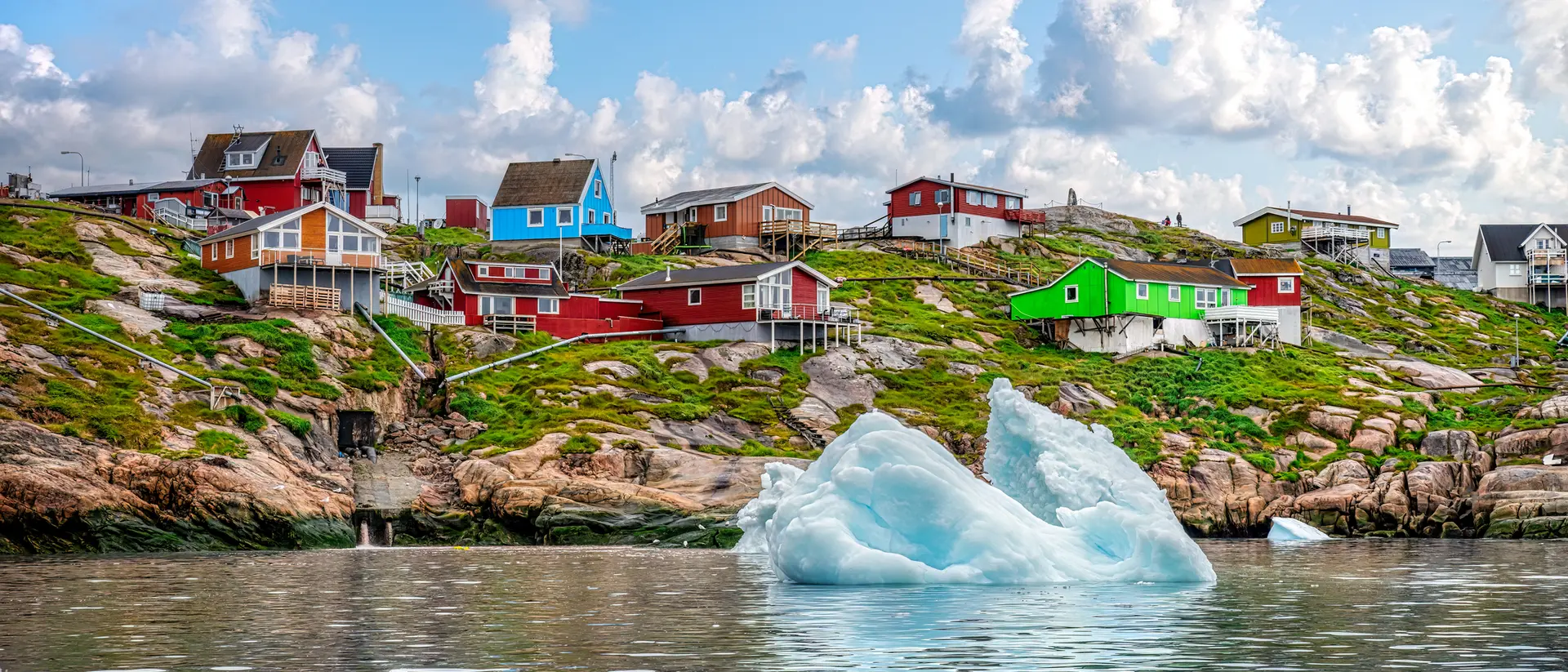 An iceberg floats in the water off the coast of Ilulissat in Greenland in summer