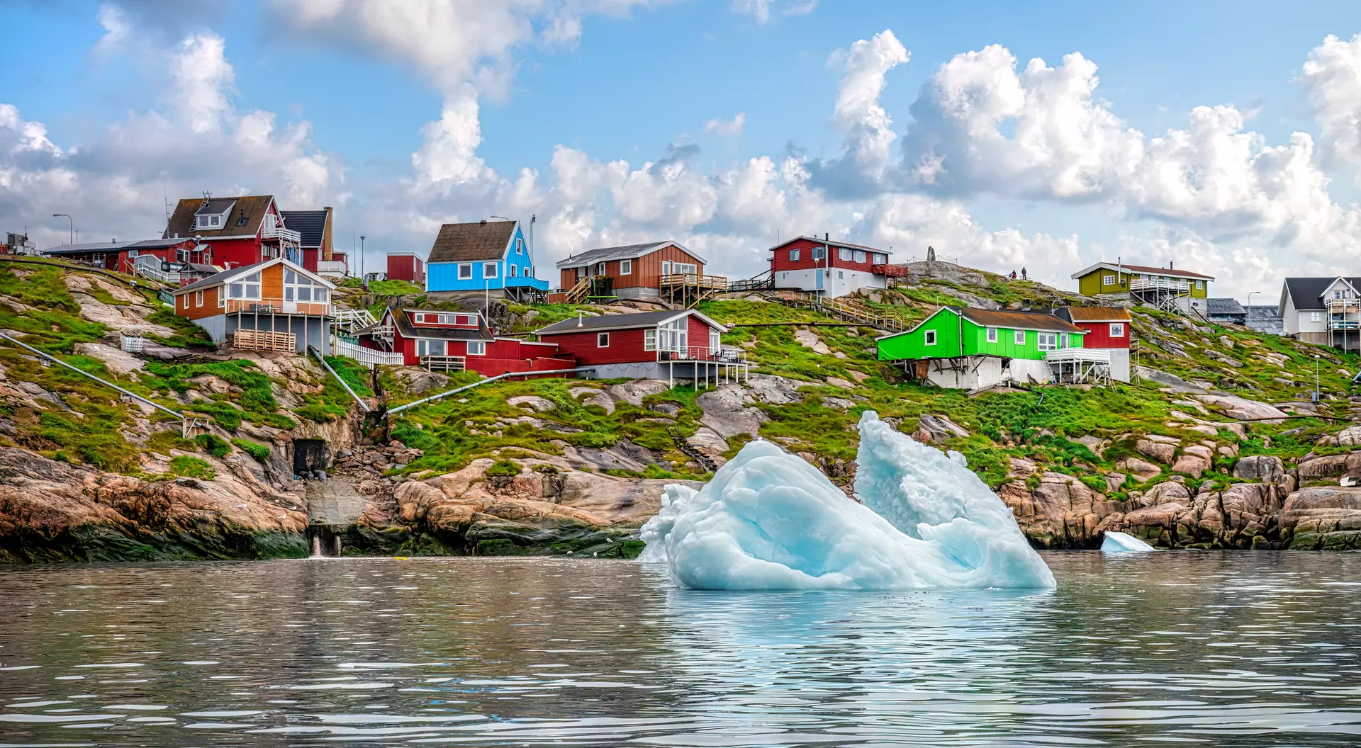 An iceberg floats in the water off the coast of Ilulissat in Greenland in summer