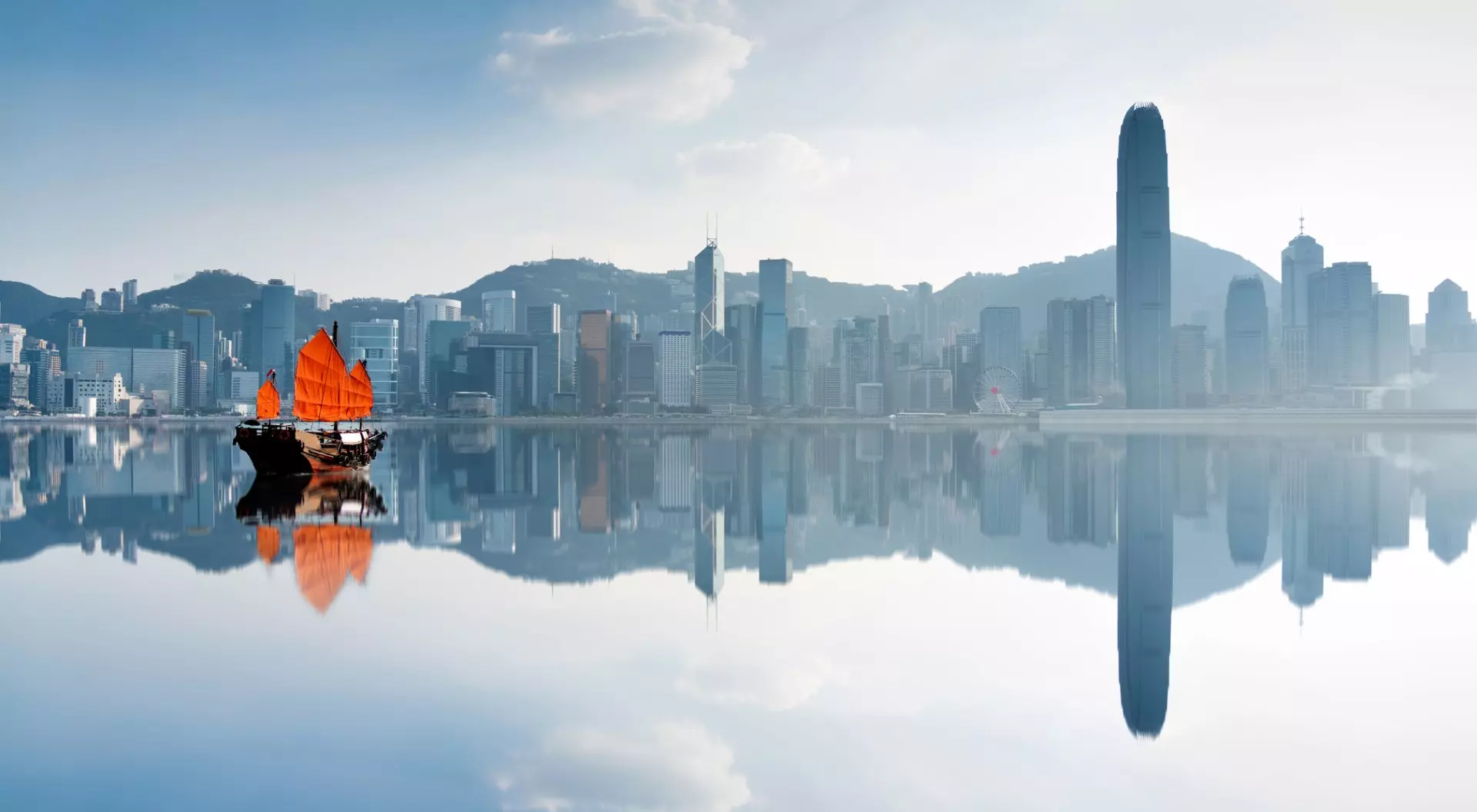 Junk boat crossing Hong Kong harbor