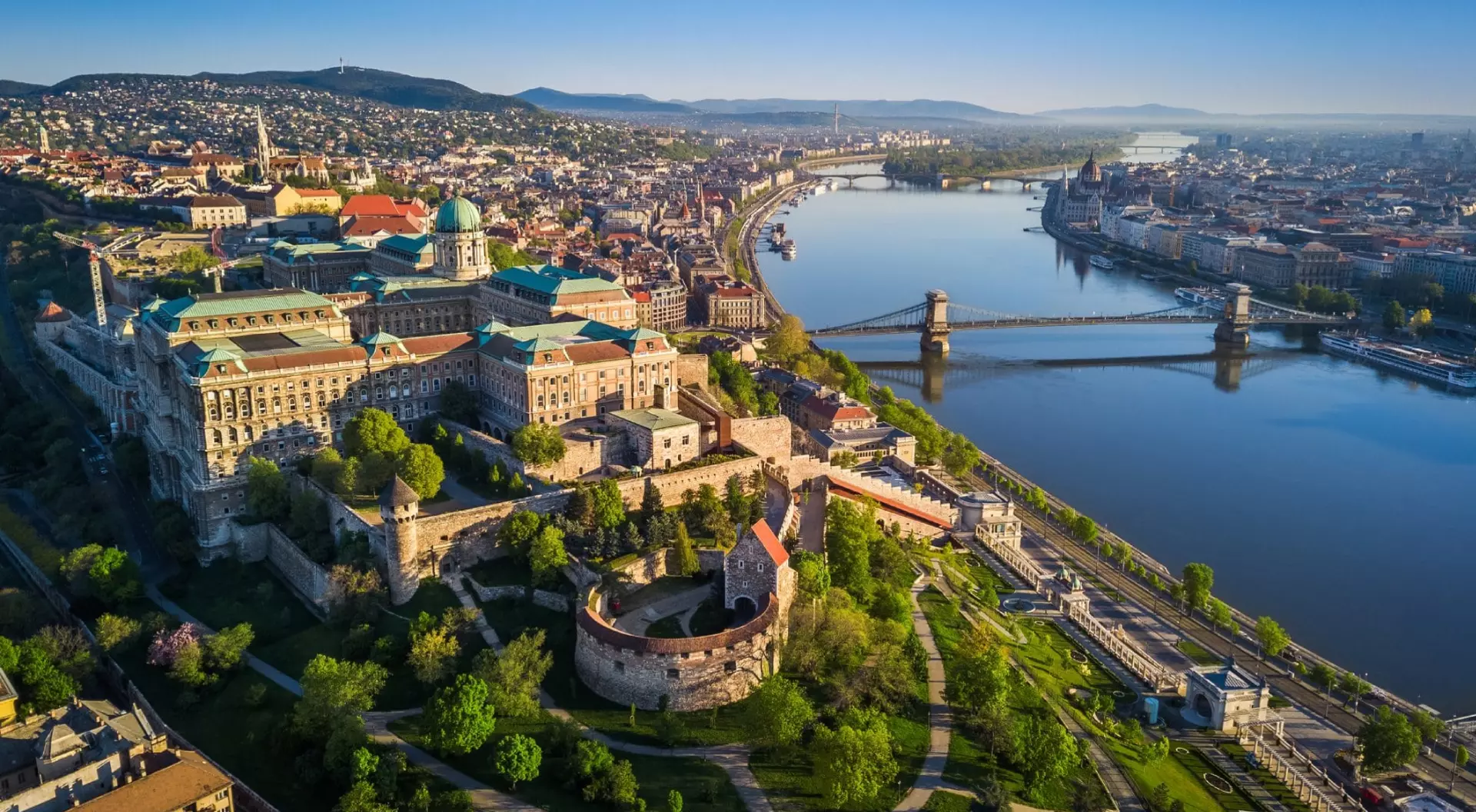 Beautiful aerial skyline view of Budapest at sunrise with Szechenyi Chain Bridge over River Danube, Matthias Church and Parliament
