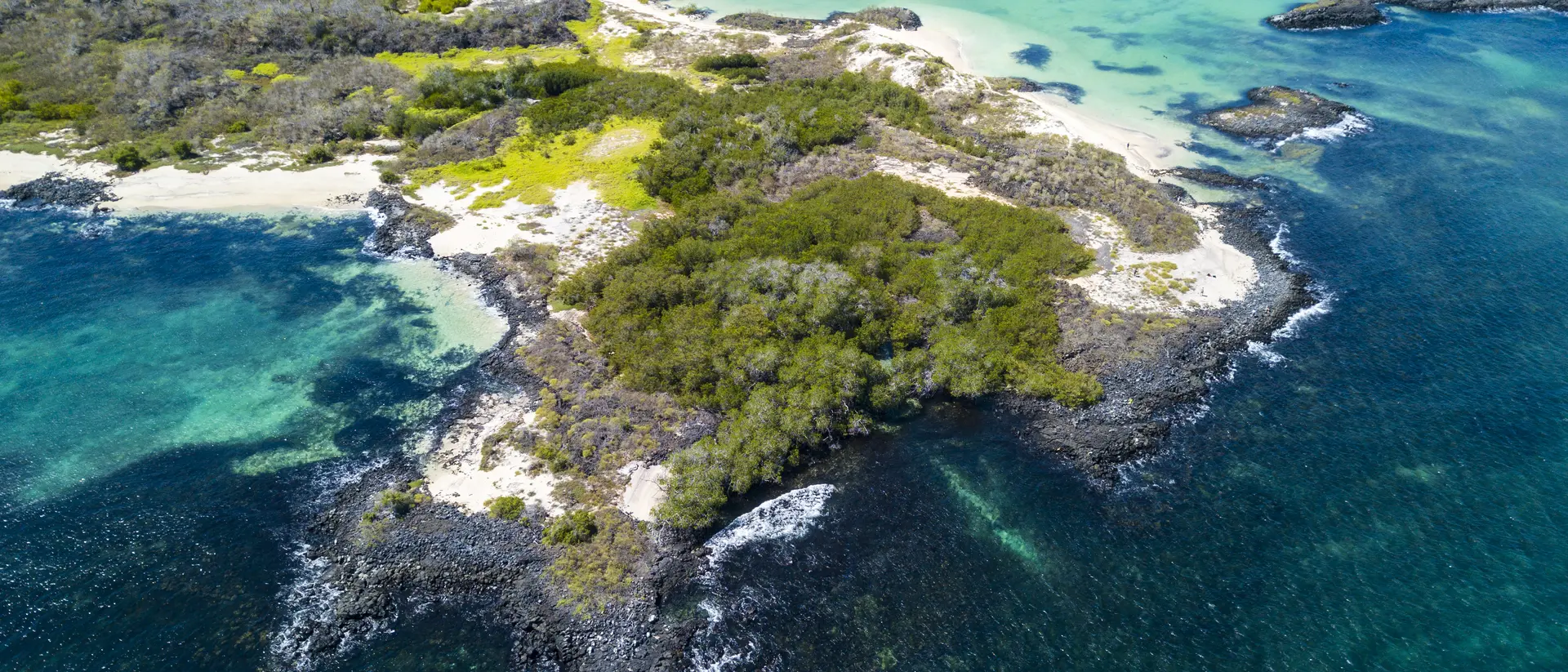 Aerial view of the sandy Cerro Brujo Beach at the north western coast of San Cristobal Island, Galapagos, Ecuador.